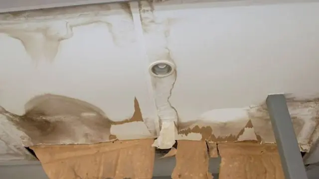 Water-damaged ceiling around a light fixture